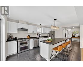 A modern kitchen with white cabinets and a central island.