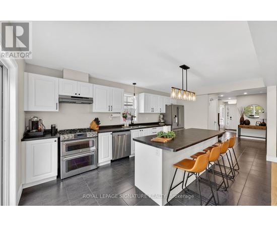 A modern kitchen with white cabinets and a central island.