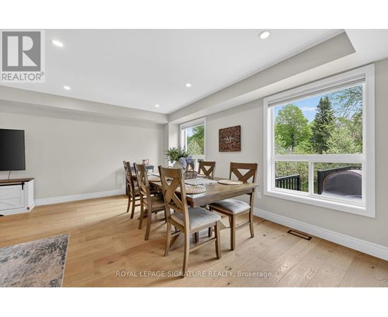A dining room with a wooden table and chairs.