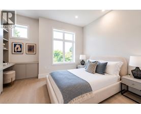 A bedroom with a large bed and a window.