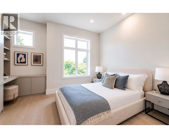 A bedroom with a large bed and a window.