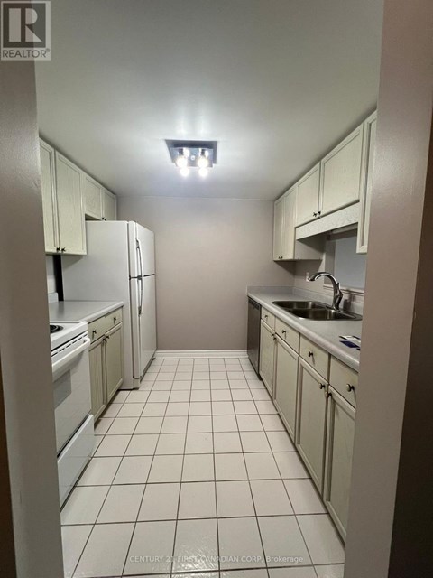 A kitchen with white cabinets and appliances.