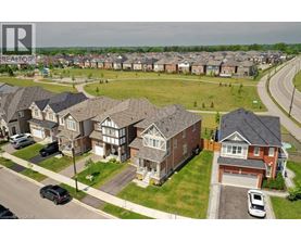 A residential area with houses and cars.