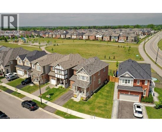 A residential area with houses and cars.
