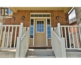 A house with a brown door and a white railing.