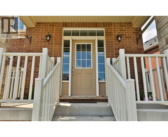 A house with a brown door and a white railing.