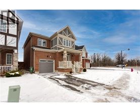 A house with a garage and a driveway covered in snow.