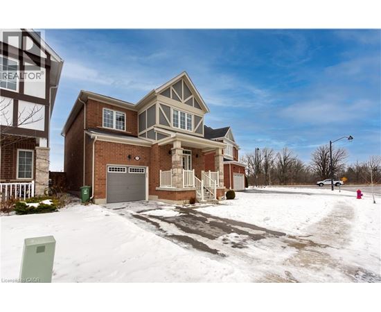 A house with a garage and a driveway covered in snow.