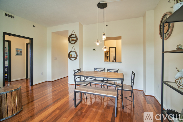 A dining room with a wooden table and chairs.