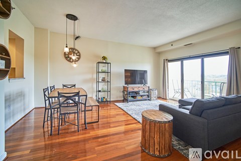 A living room with a dining table and chairs.