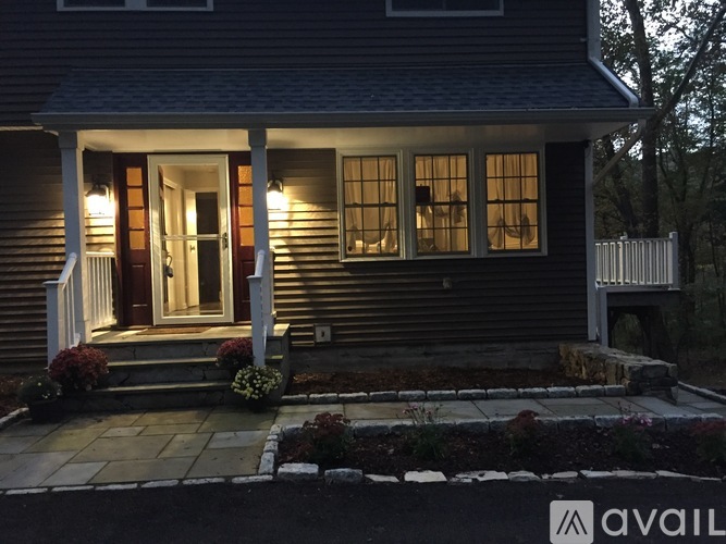 A house with a porch and lights on.