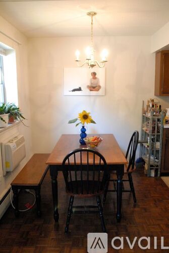 A dining room with a wooden table and chairs.