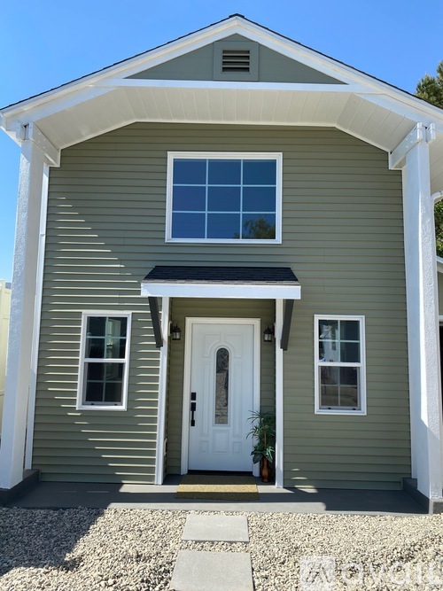 A house with a white door and windows.