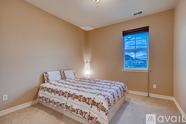 A bedroom with a bed and a window.