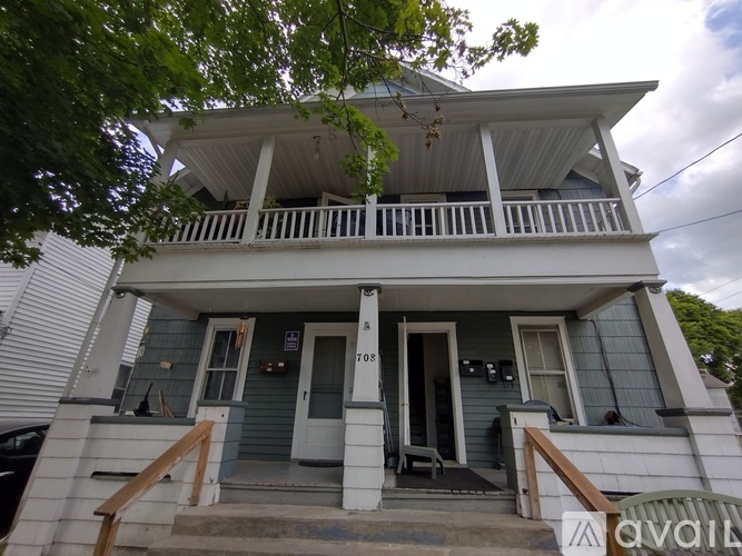 A two-story house with a balcony on the second floor.