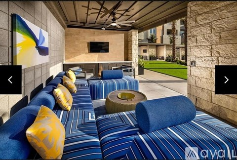 A living room with a blue couch and a television.