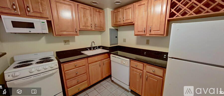 A kitchen with wooden cabinets and a white refrigerator.
