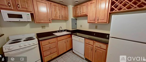 A kitchen with wooden cabinets and a white refrigerator.