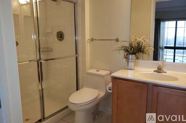 A bathroom with a toilet, sink, and shower.
