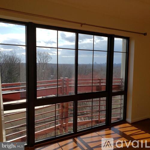 A room with a large window overlooking a red bridge.
