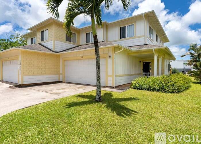 A house with a tree in front of it.