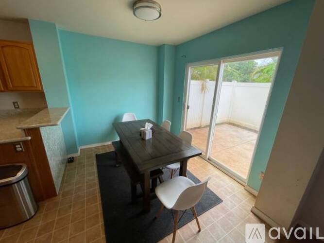 A dining room with a table and chairs.