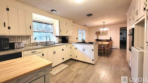 A kitchen with wooden cabinets and a large island.