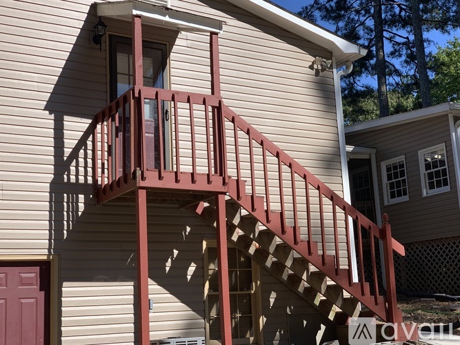 A house with a red staircase and a red door.