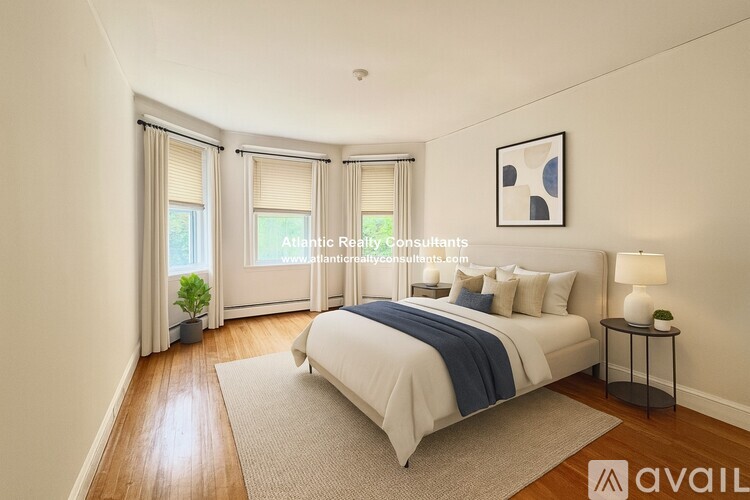 A bedroom with a large bed and a plant in a pot.