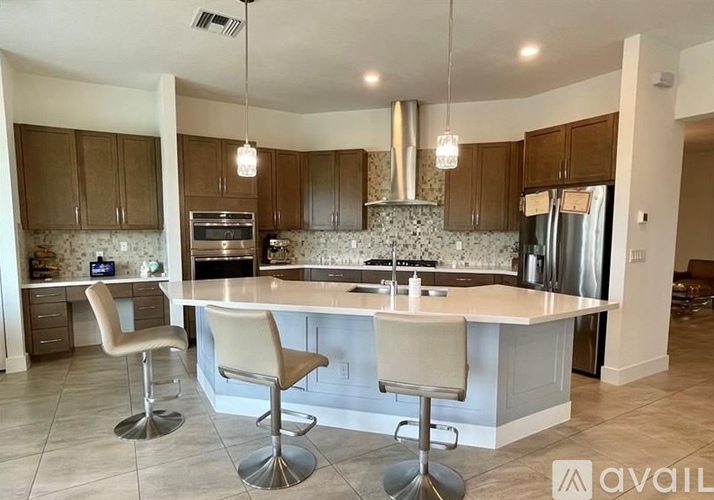 A kitchen with a bar area and two stools.