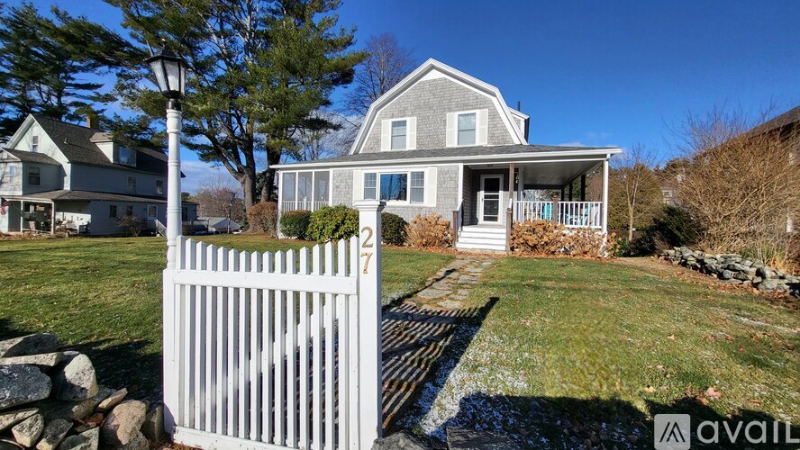 A house with a white picket fence in front.