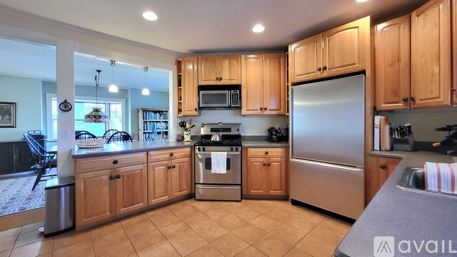 A kitchen with wooden cabinets and stainless steel appliances.