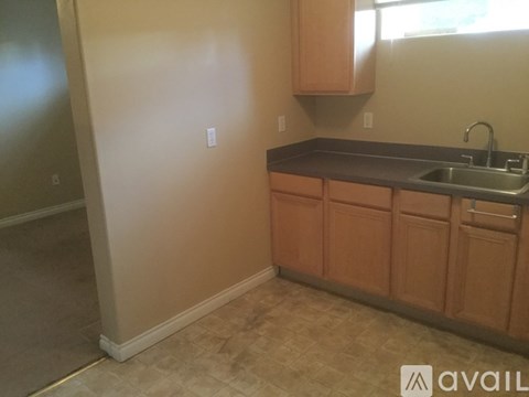 A kitchen with wooden cabinets and a sink.