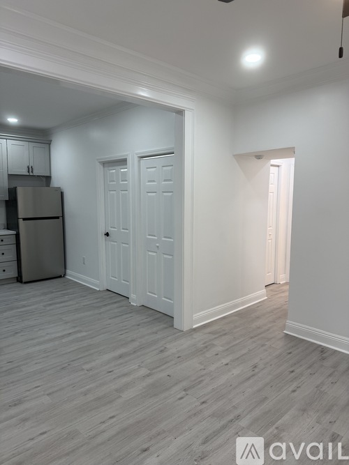 A kitchen with a refrigerator and cabinets.