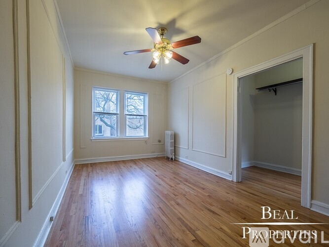 A room with a ceiling fan and a window.