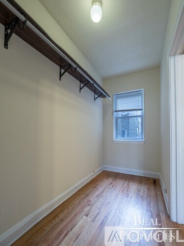 A room with wooden floors and a window.