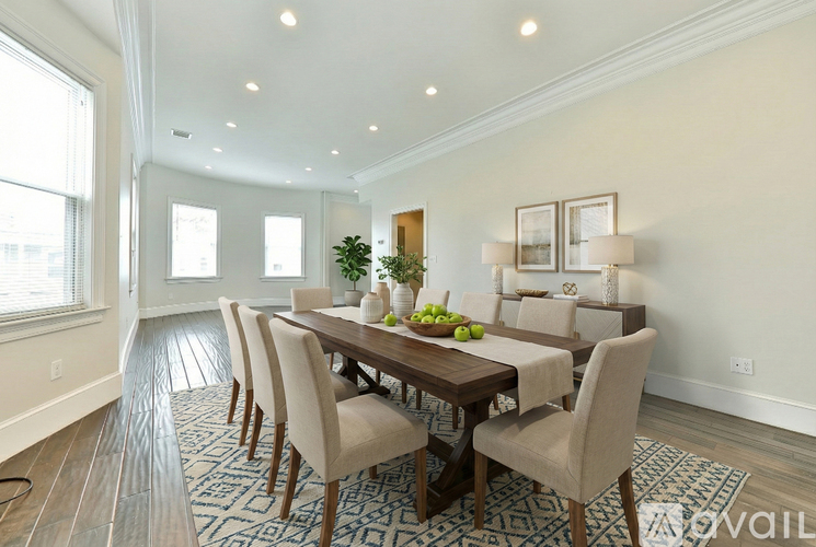 A dining room with a table set for four.