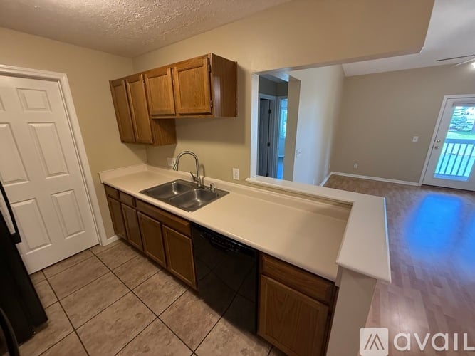 A kitchen with brown cabinets and a white countertop.