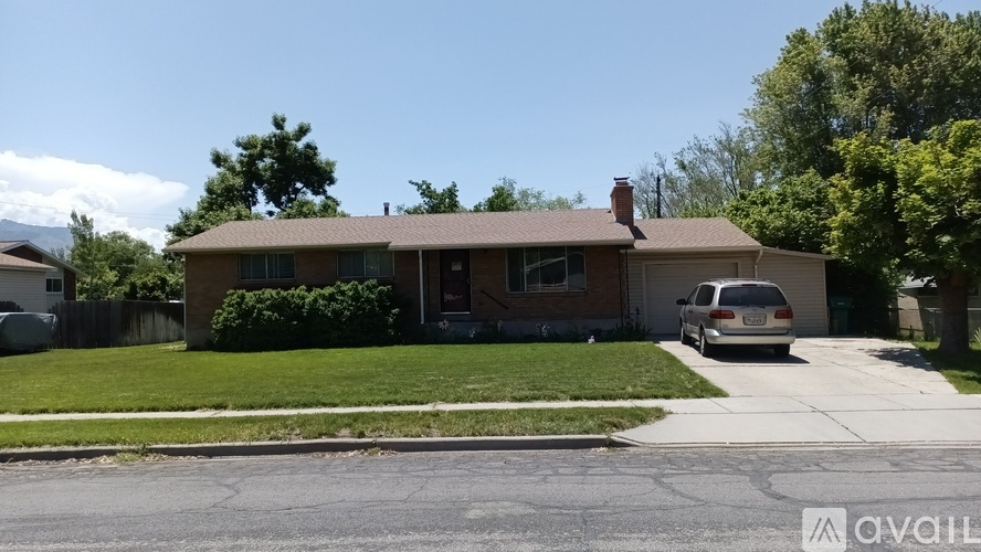 A house with a car parked in front.