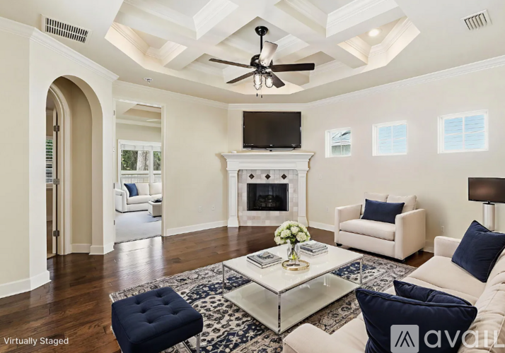 A living room with a fireplace and a television.