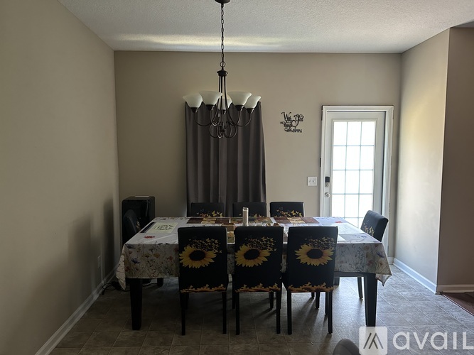 A dining room with a table set for six.