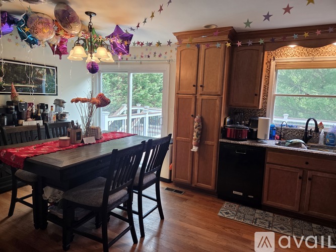 A kitchen with a table and chairs and a window.