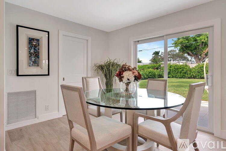 A dining room with a glass table and chairs.