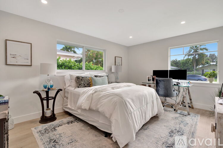 A bedroom with a large bed and a window overlooking a street.