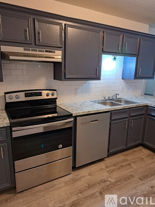 A kitchen with a stove top oven and a dishwasher.