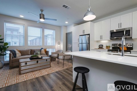 A modern kitchen with white cabinets and a large island.