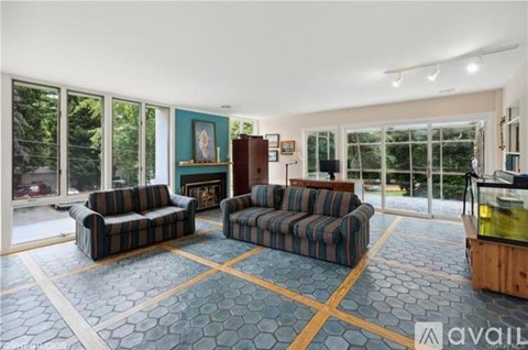 A living room with two couches and a fireplace.