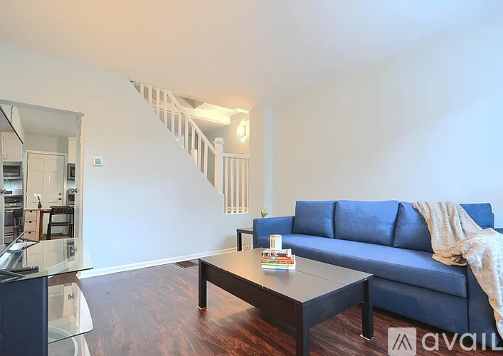 A living room with a blue couch and a coffee table.