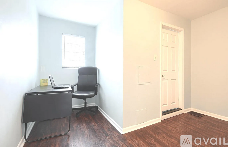 A room with a desk and chair in it.