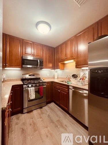 A kitchen with wooden cabinets and stainless steel appliances.